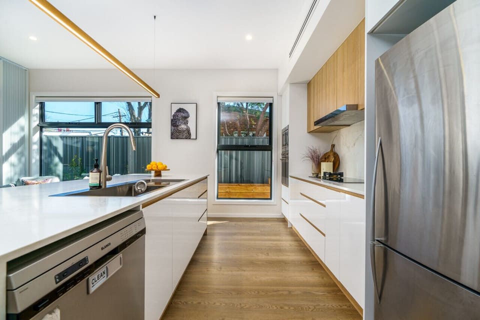 Step into culinary delight in this chic kitchen adorned with stainless steel appliances. Get ready to create cherished memories in this perfect cooking haven.