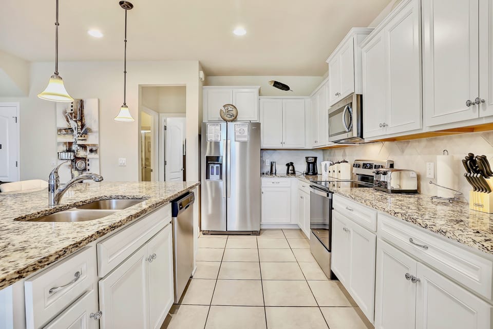 A fully equipped kitchen with all the utensils and appliances that you could need