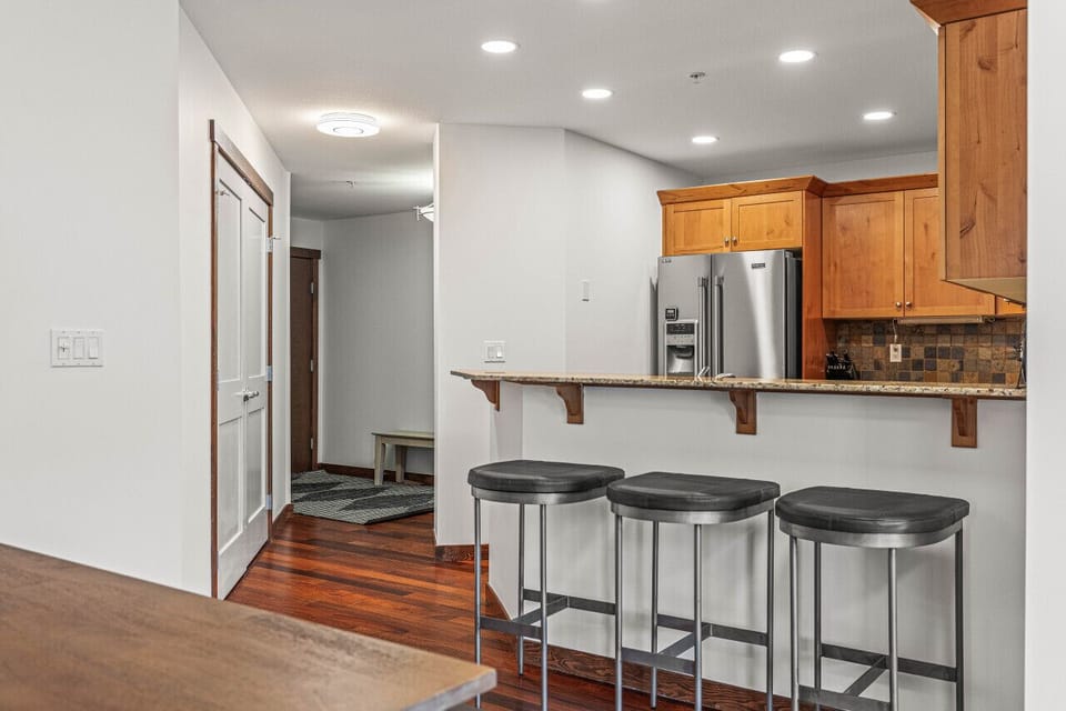 Bar stools for three people create a social setting while cooking dinner