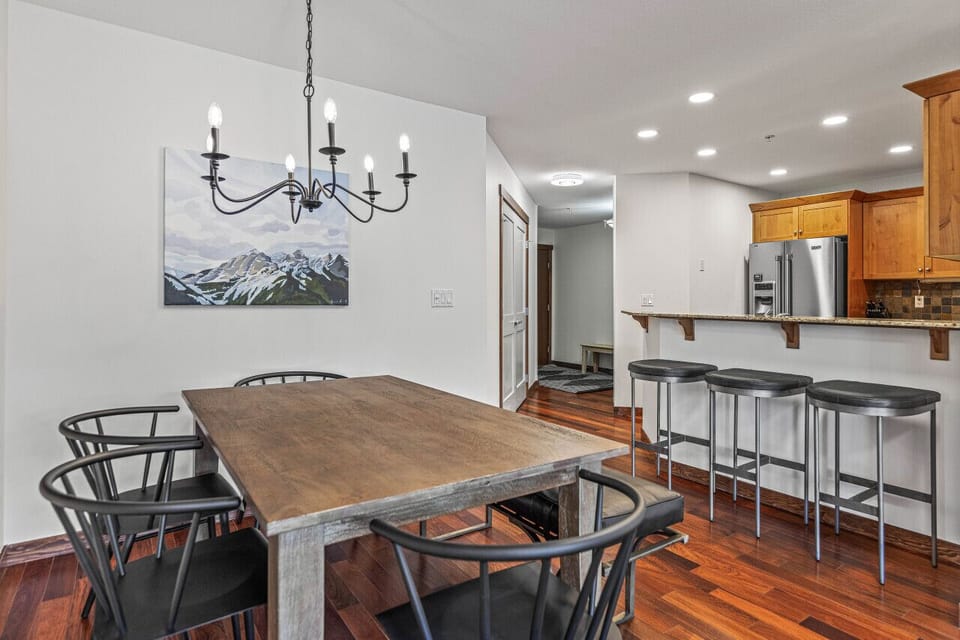 Dining area with elegant candle bulb chandelier comfortably seats 6 people