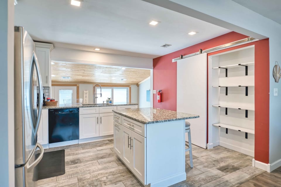 A bright, generously sized kitchen with abundant storage for all your grocery and pantry needs.