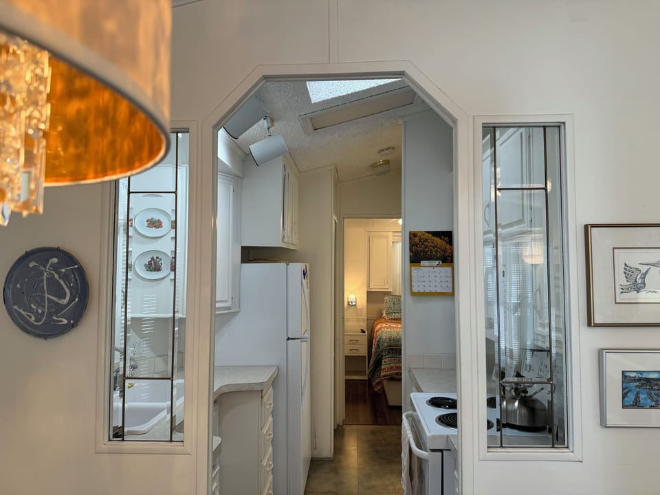 View from living/dining into kitchen and main bedroom