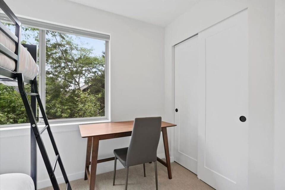 SECOND FLOOR: Bedroom 2: Furnished with a queen bed, blackout curtains, soft lighting, natural light, and a spacious close