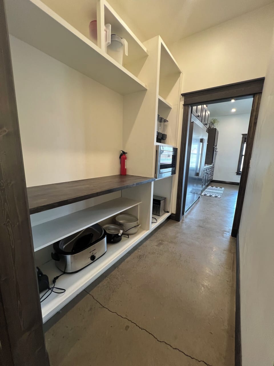 Enormous pantry with microwave, cereal dispensers, and small kitchen appliances