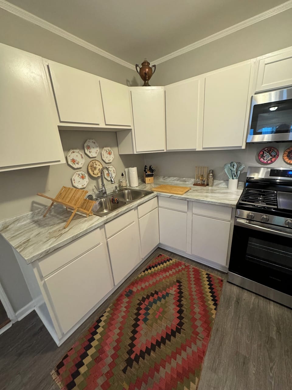 Kitchen with gas stove, full refrigerator, dishes, cookware, Kuerig/French press