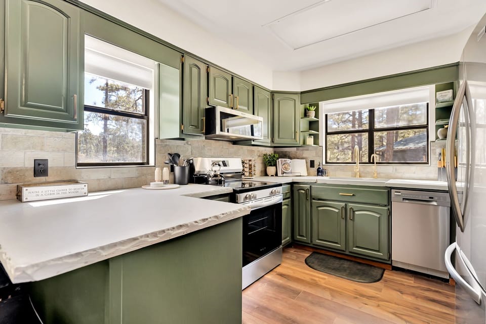 Our fully stocked kitchen boasts a refreshing palette of white and green.