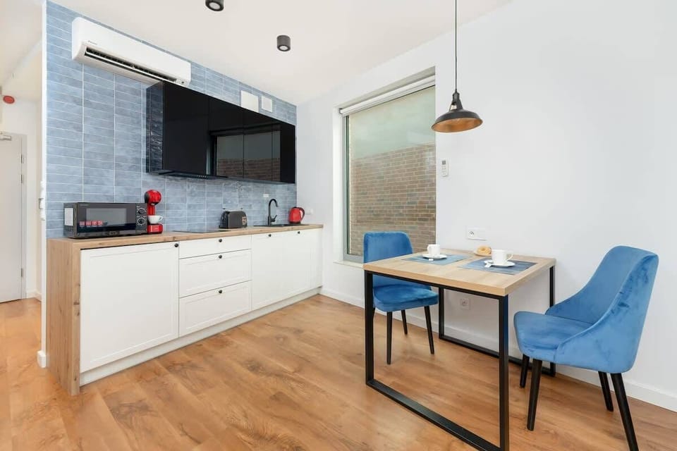 The kitchenette and dining table with chairs where you can enjoy meals together comfortably. 