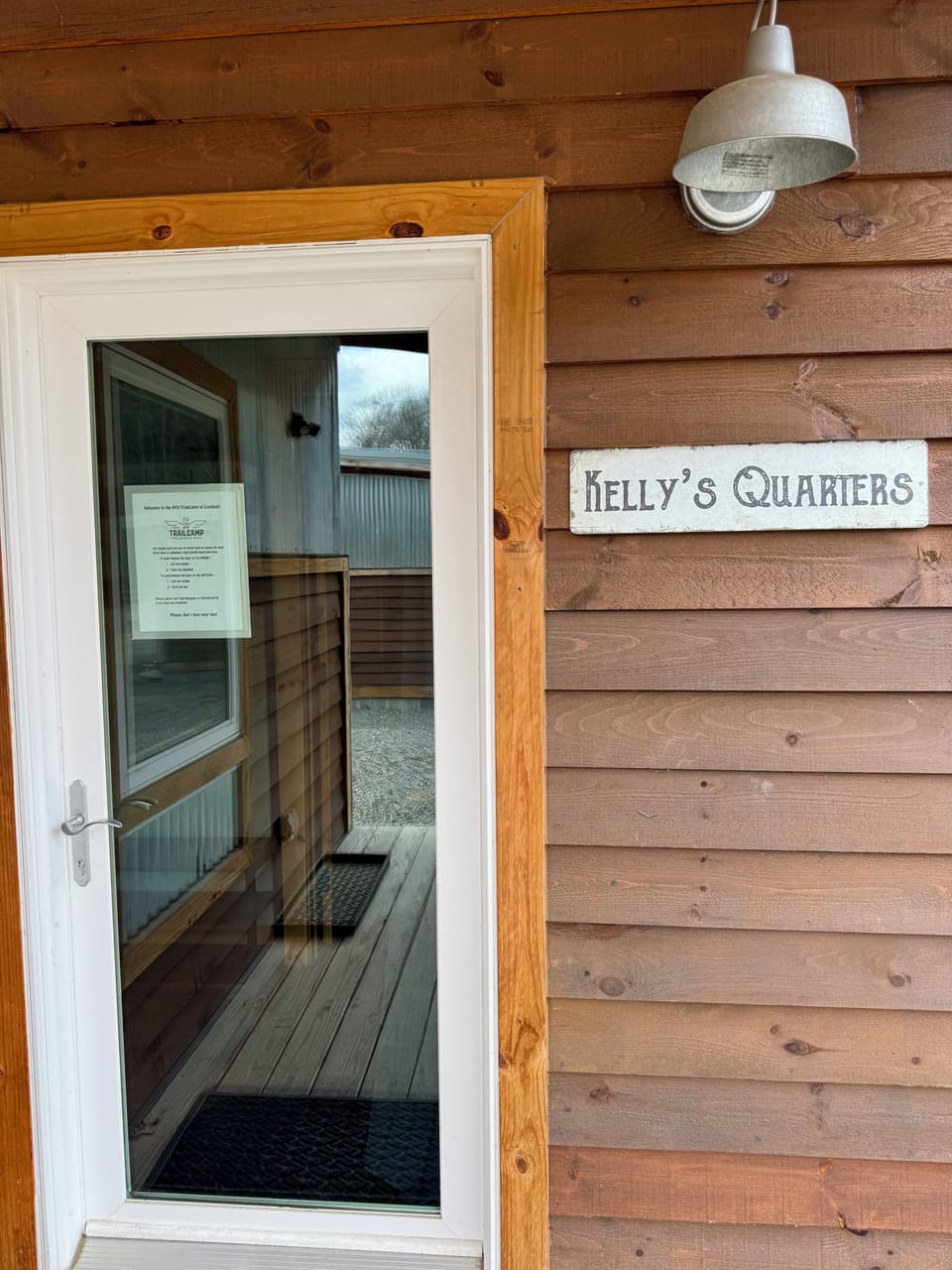 Front entrance with signage and lockbox.