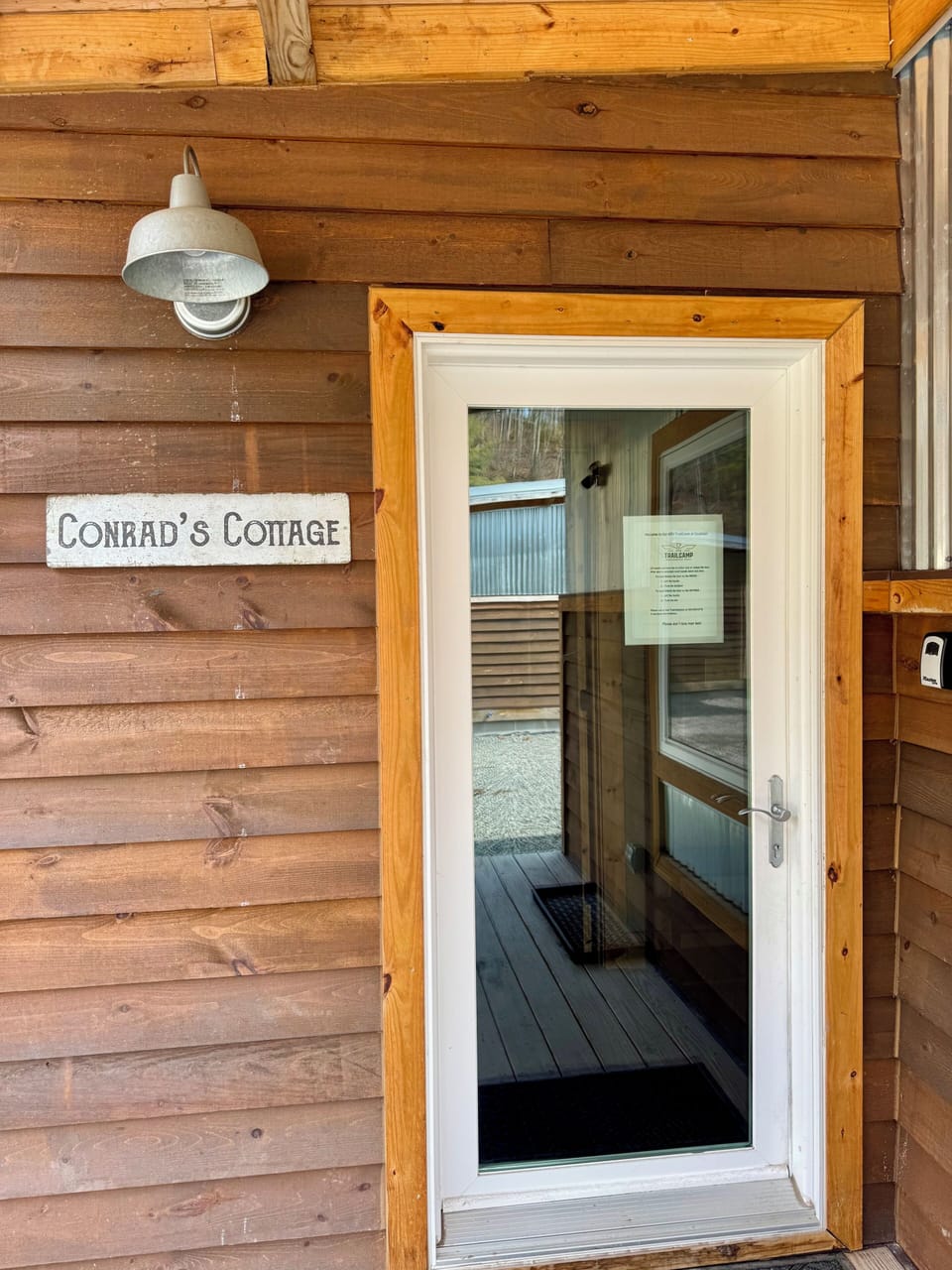 Front entrance with signage and lockbox.