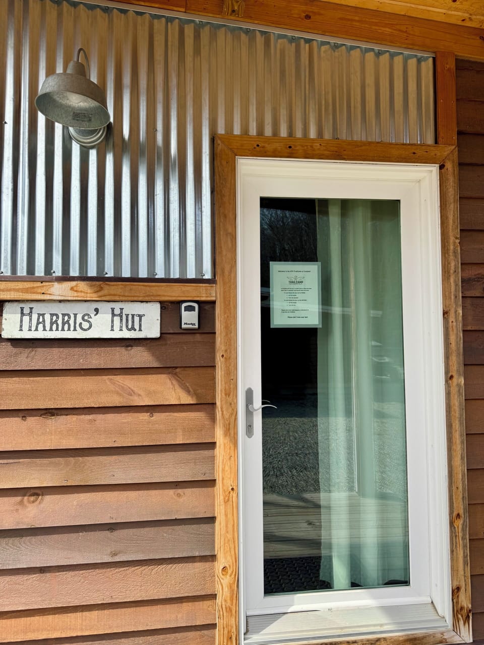 Front entrance with signage and lockbox.