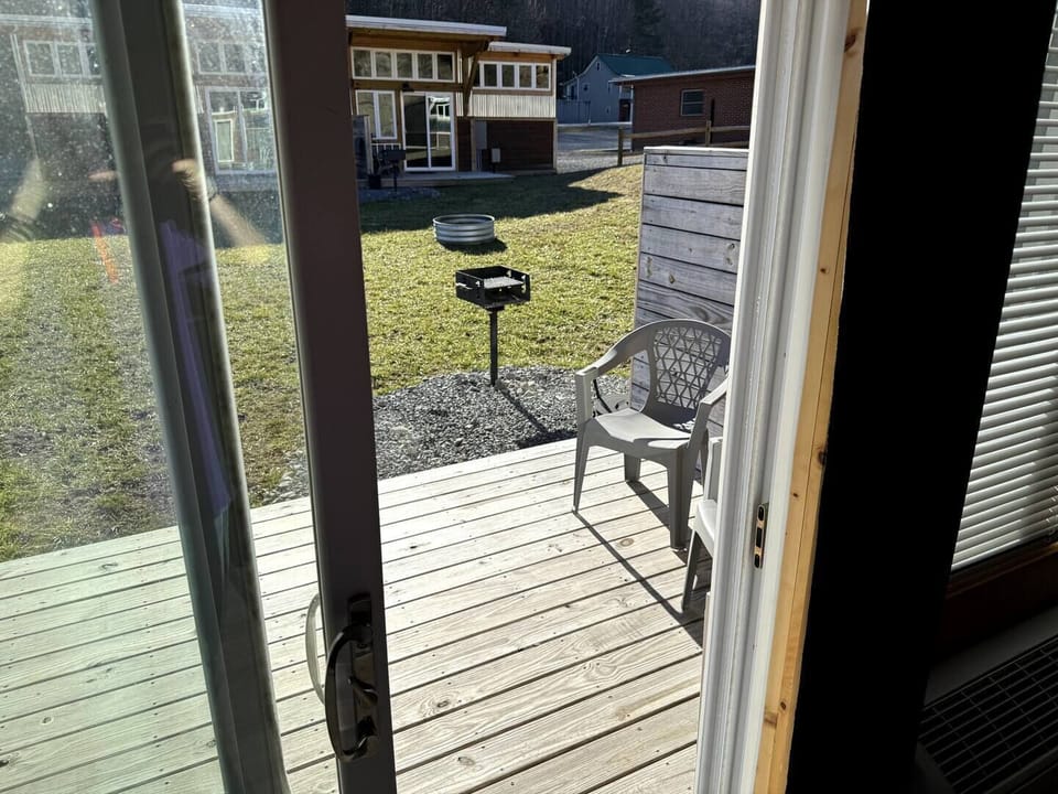 Back porch with charcoal grilled shared with neighboring unit.