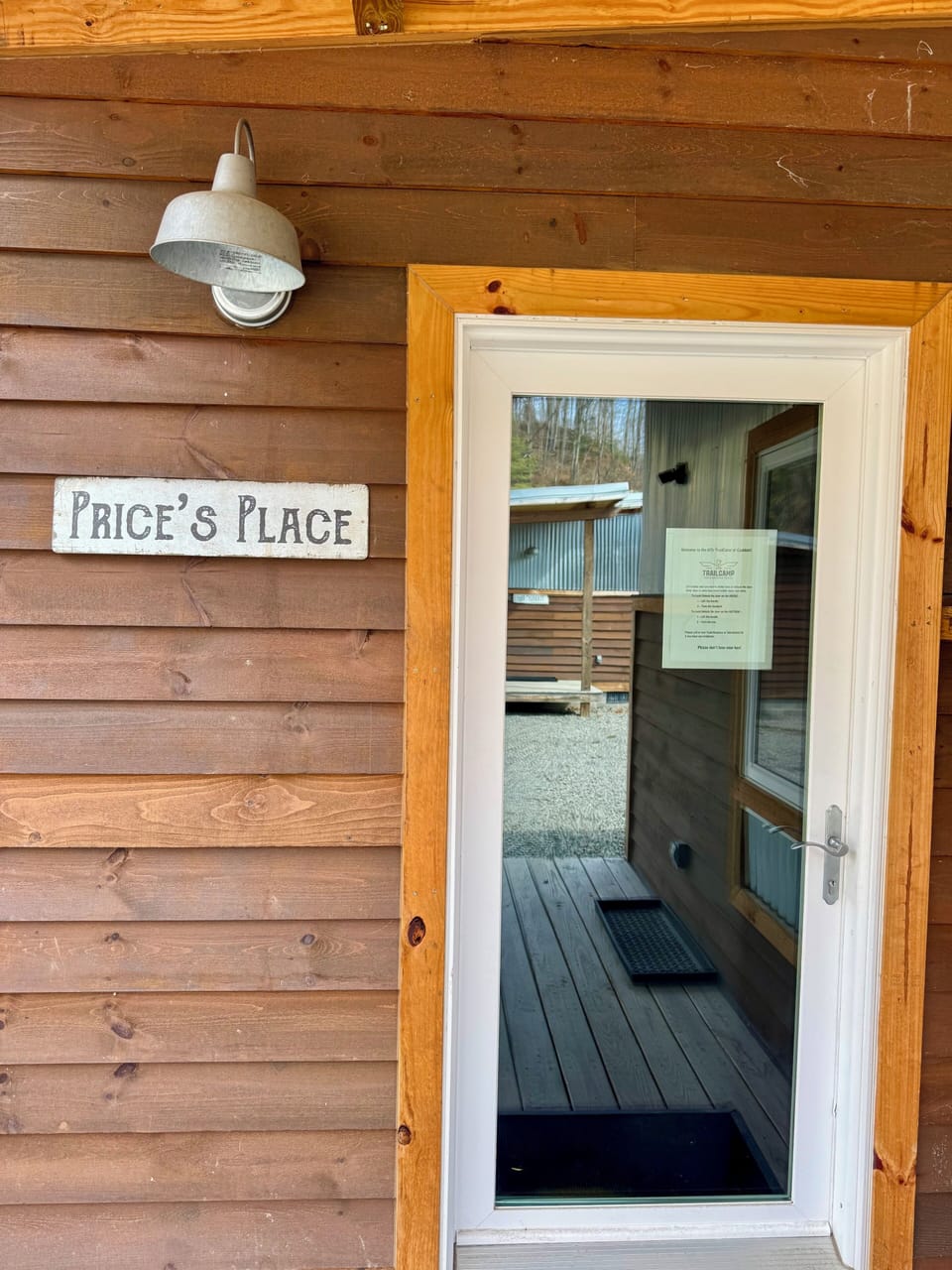 Front entrance with signage and lockbox.