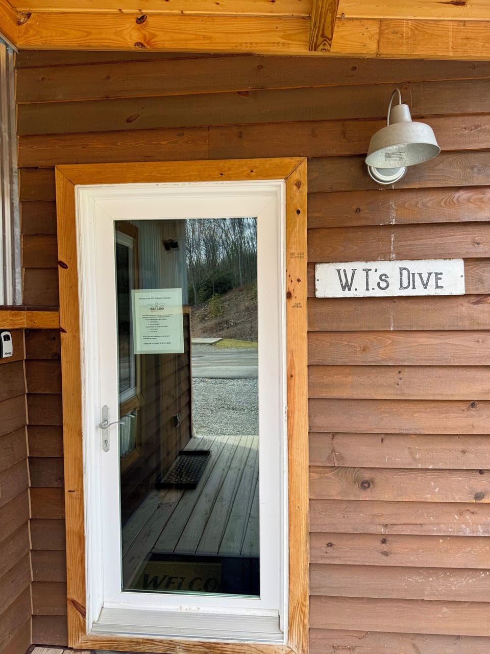 Front entrance with signage and lockbox.
