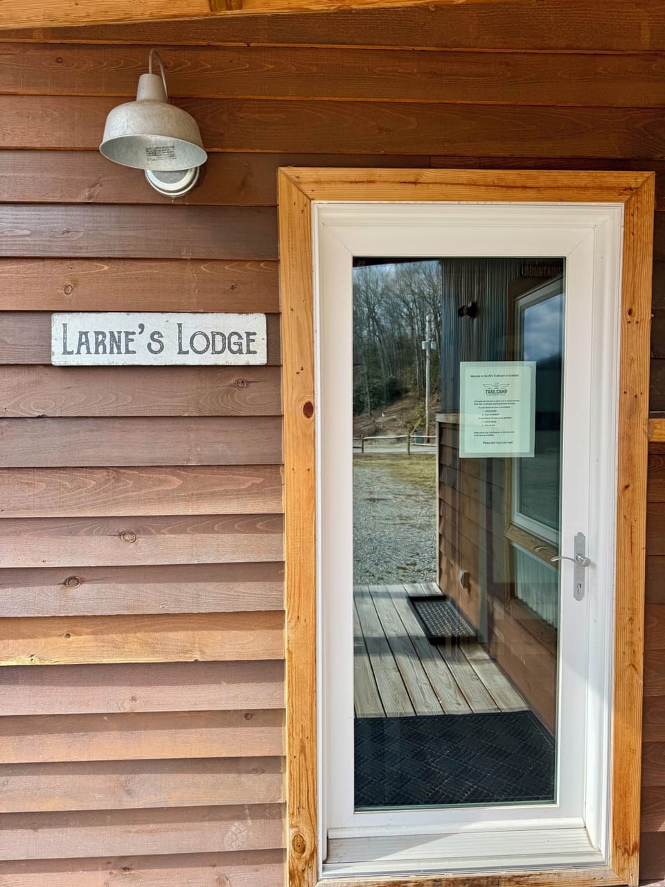 Front entrance with signage and lockbox.