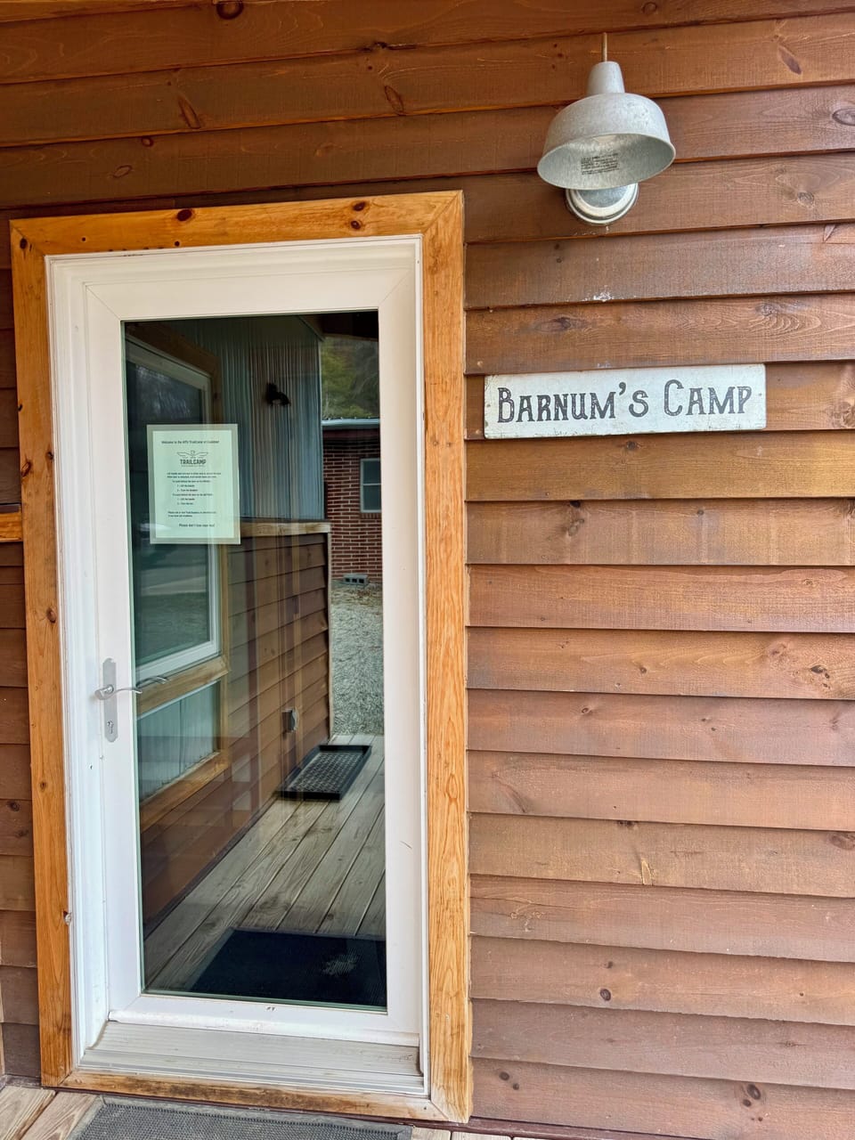 Front entrance with signage and lockbox.