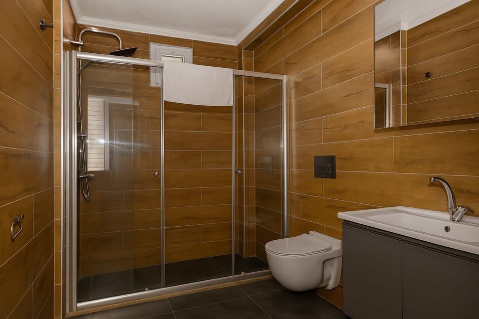 Deluxe Quadruple Room, Multiple Beds | Bathroom | Shower, hair dryer, towels, soap