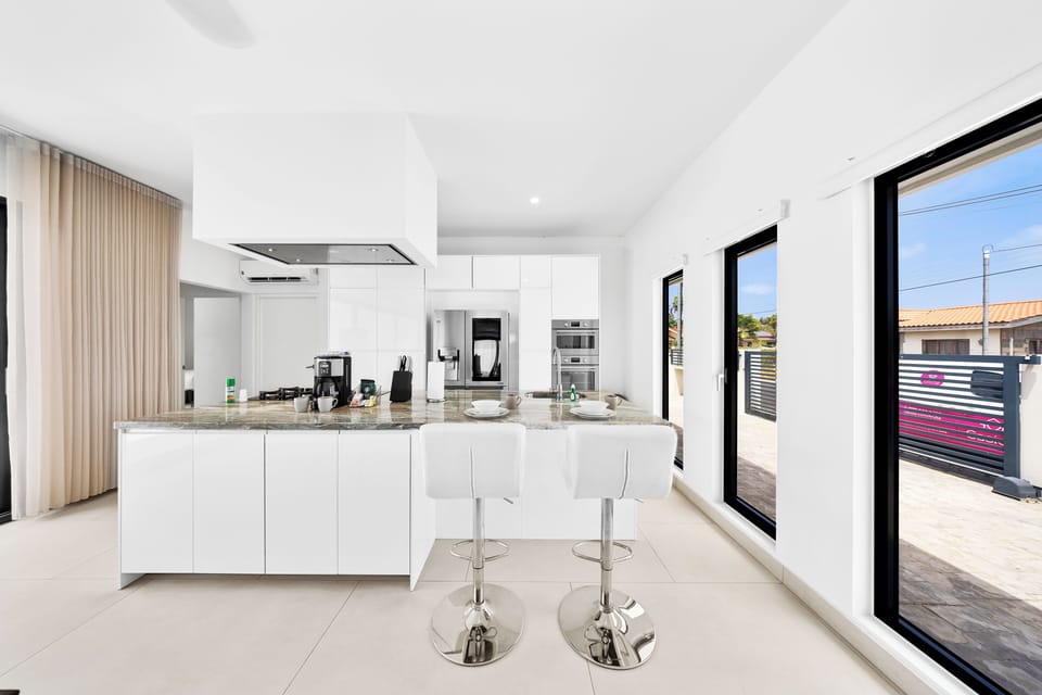 Fully Equipped Kitchen of the home in Noord, Aruba - Availability of stainless steel appliances and all necessary kitchen accessories - Plenty of space to store goods  - Big and bright windows with outside views