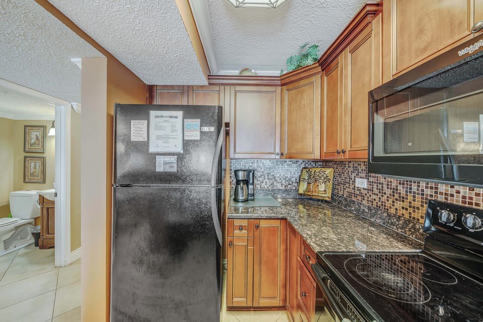 The fully equipped kitchen features granite countertops and has everything you need to prepare meals for family and friends.