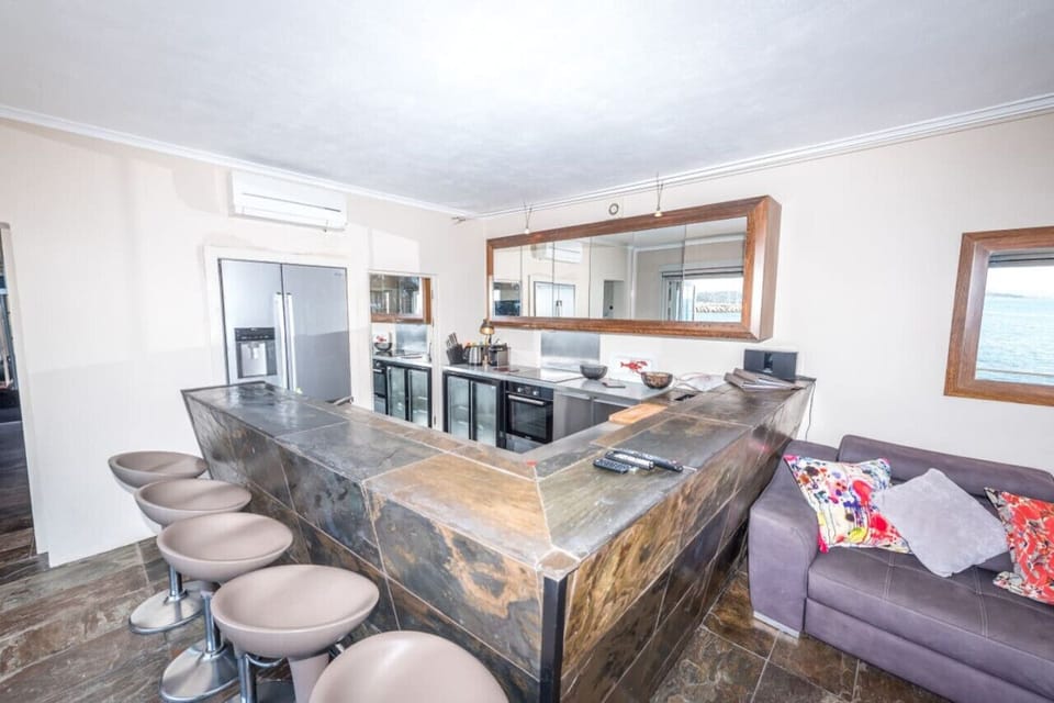 Open-plan kitchen with breakfast bar and sea view