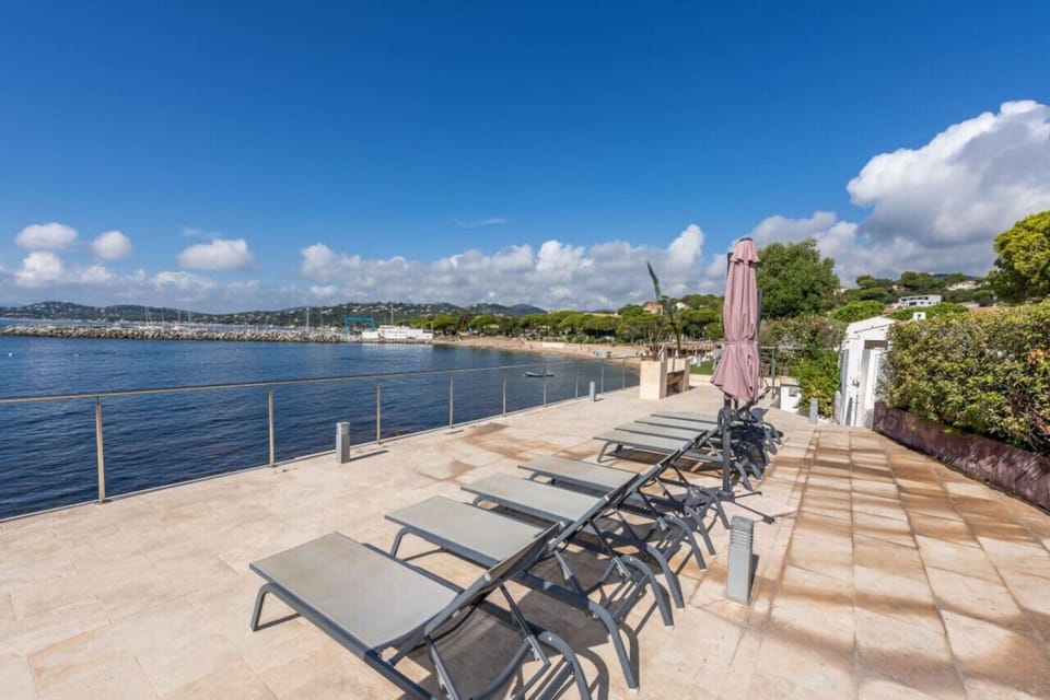 Sun loungers lined along the seafront terrace