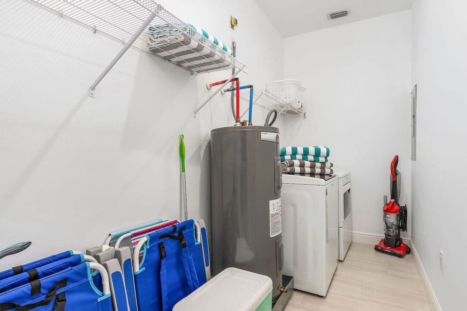 Laundry room with washer and dryer and this is where you'll find the beach equipment stored.