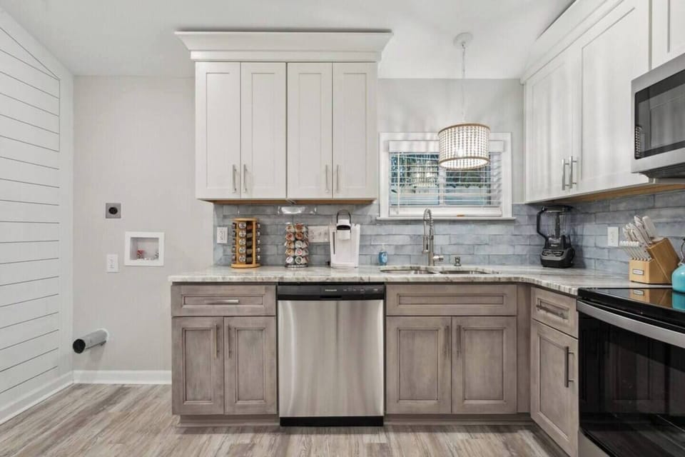 This well-equipped full kitchen provides everything you need to create delicious meals.  Top-of-the-line appliances, including a built-in oven, electric stove with four burners, and spacious refrigerator, offer functionality and power for all your culinary creations.  Granite countertops provide ample prep space, while numerous drawers ensure all your cooking essentials are wit...