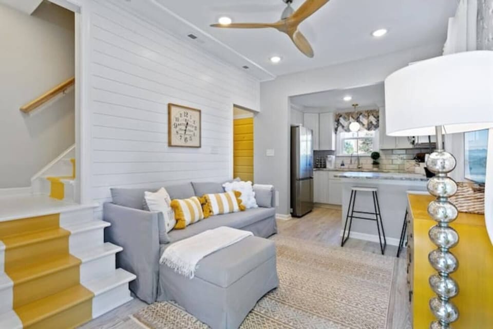  This inviting living room offers a perfect blend of comfort and functionality. Unwind on the plush grey sofa and enjoy your favorite shows on the smart TV. The spacious layout with carpeted flooring and layered rugs provides ample space for relaxation and entertaining. The convenient staircase leads seamlessly to the second floor, creating a well-connected living environment. ...
