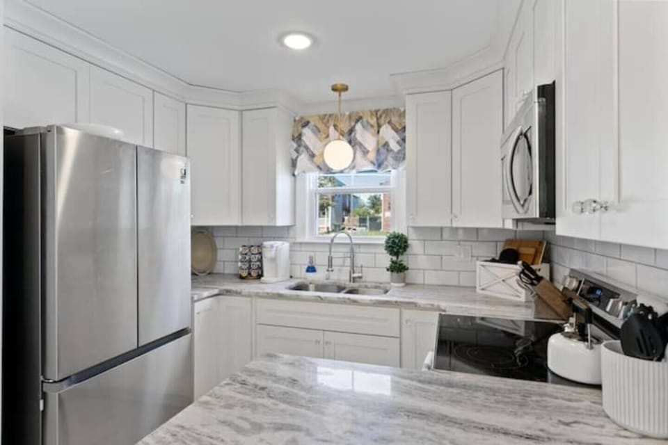 This well-appointed full kitchen is a chef's dream come true.  Unleash your culinary creativity with the top-of-the-line appliances, including a built-in oven, electric stove with four burners, and spacious refrigerator.  Granite countertops provide ample prep space, while numerous drawers ensure all your cooking essentials are within reach.  Sharpen your skills with a set of h...