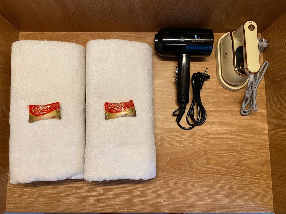 Premium bedding, desk, laptop workspace, blackout drapes