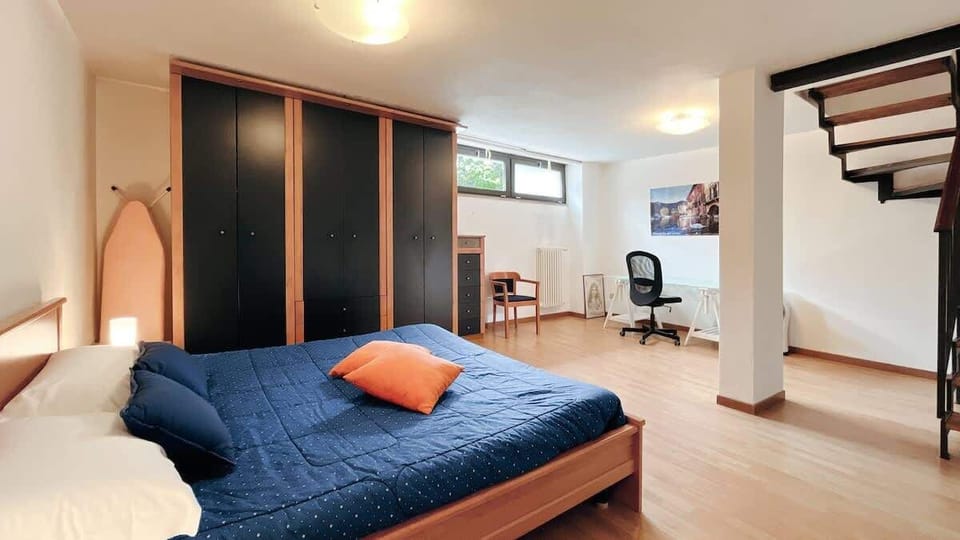 Bedroom with walk-in wardrobe and desk