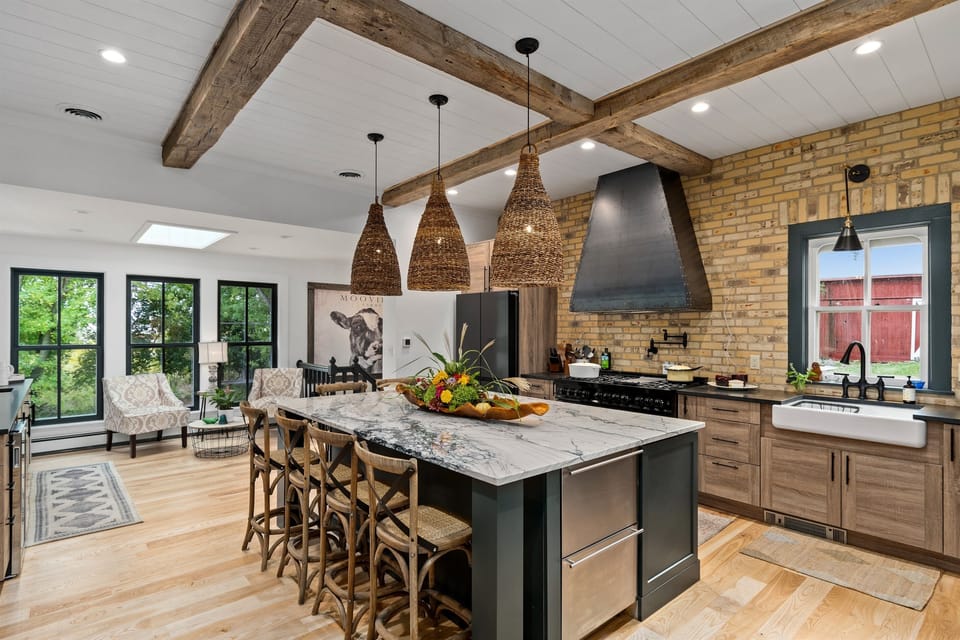 Bright, updated kitchen w/ farmhouse sink & generous island workspace.