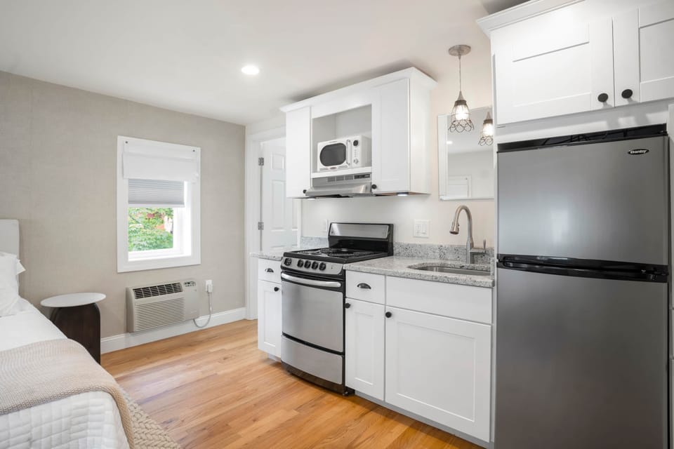 Kitchen with essentials. Glassware, utensils, baking sheets, cutting boards, and more.