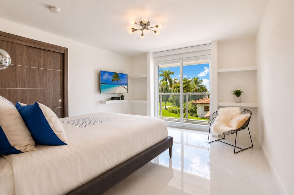 Bright modern bedroom with tropical views and abundant natural light