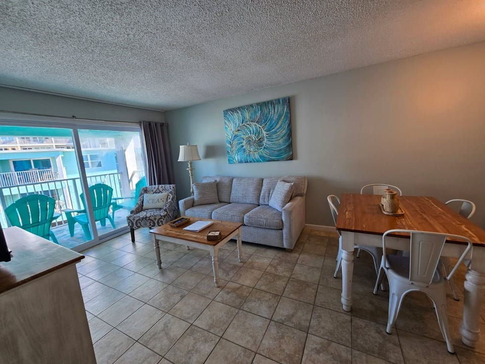 The cozy living room is adorned with a brand-new plush sofa, perfect for enjoying your favorite shows on the smart TV.