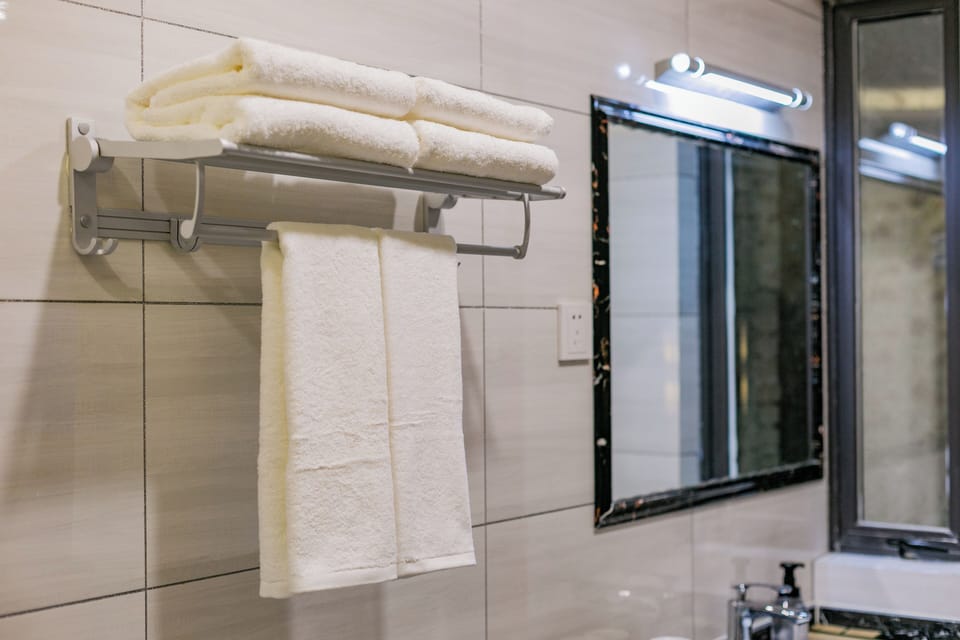 Shower, hair dryer, slippers, towels