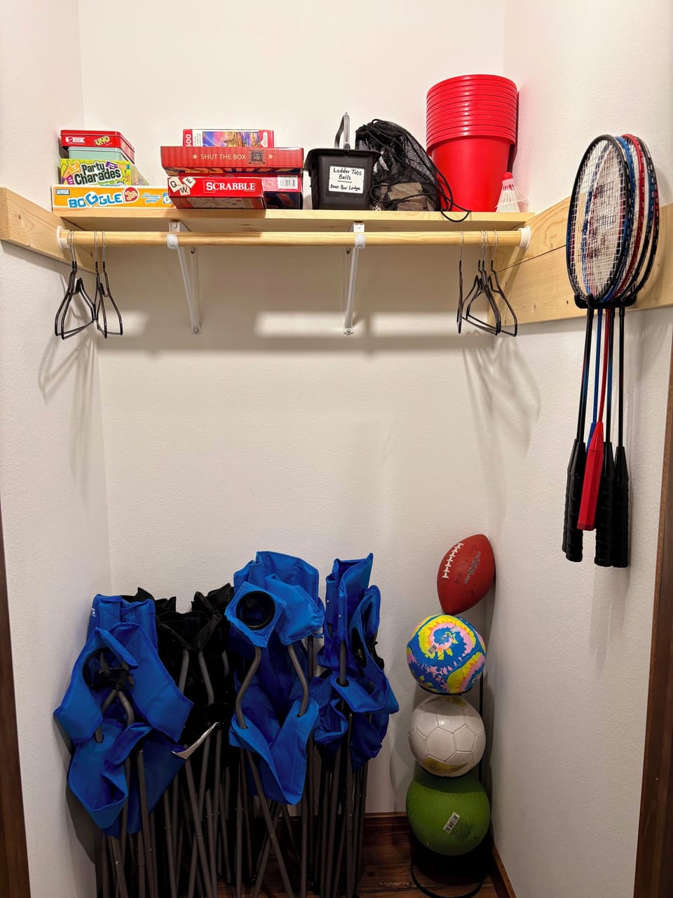 Closet by the front door stocked with board games, playing cards, balls, etc.