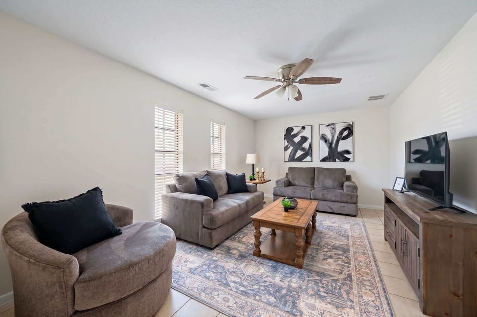Living Room: Relax in style with chic art, plush seating, and bright natural light!