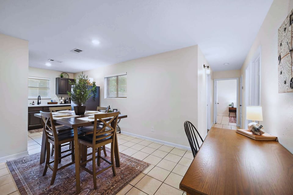 Dining Area: Gather around the stylish table and enjoy meals with friends in this vibrant space!