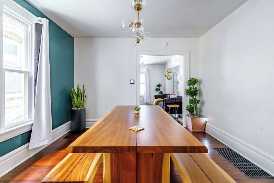 Family Meals, Group Style: Enjoy meals together in this spacious dining area, featuring a large table and seating designed for families and groups. A simple yet elegant space