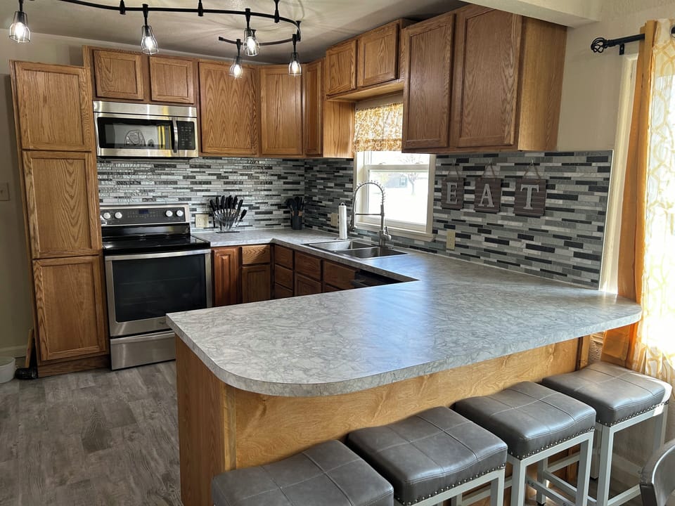 Lots of counter space to meet all your cooking needs. Electric stove/oven and large microwave.