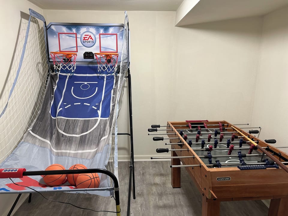 Basement game room: includes a dual arcade basketball hoop, as well as a foosball table.