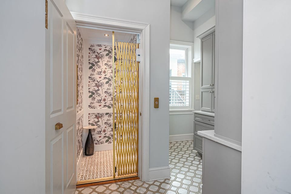 At the back of the home, an elevator will ascend you to the third floor or ground level of the home.