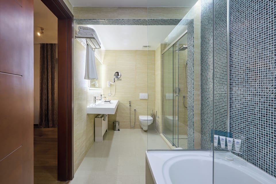 Elite Suite | Bathroom | Separate tub and shower, rainfall showerhead, hair dryer, slippers