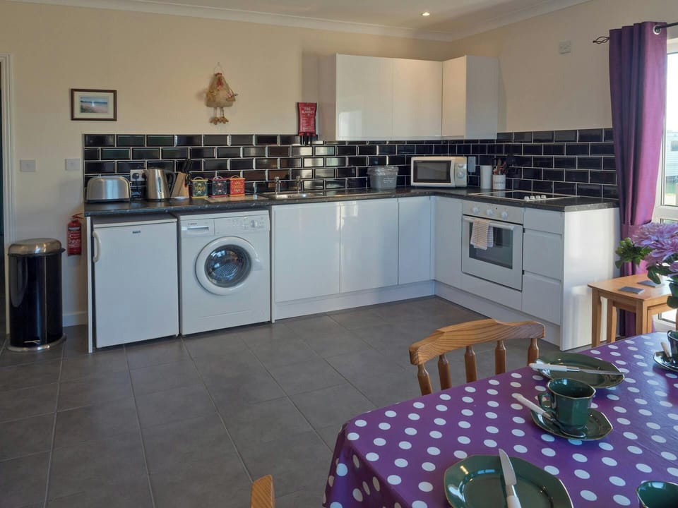 Fridge, washing machine, microwave, kettle, toaster, built-in oven and hob, dining table and chairs