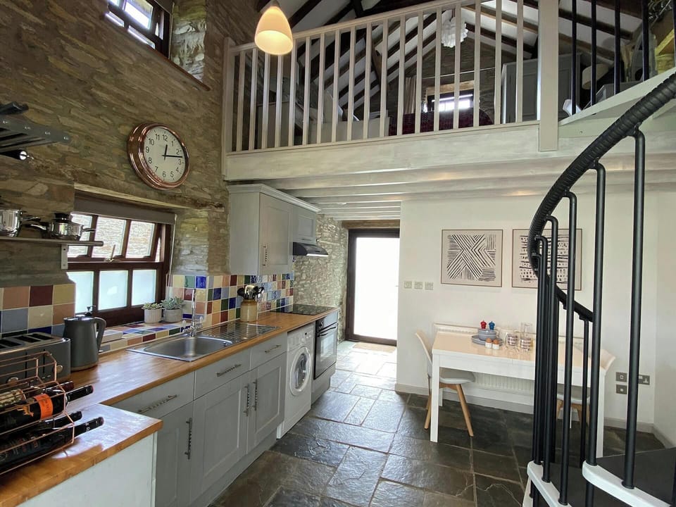 Granary Cottage with a dining table to seat 2 and door leading outside to garden