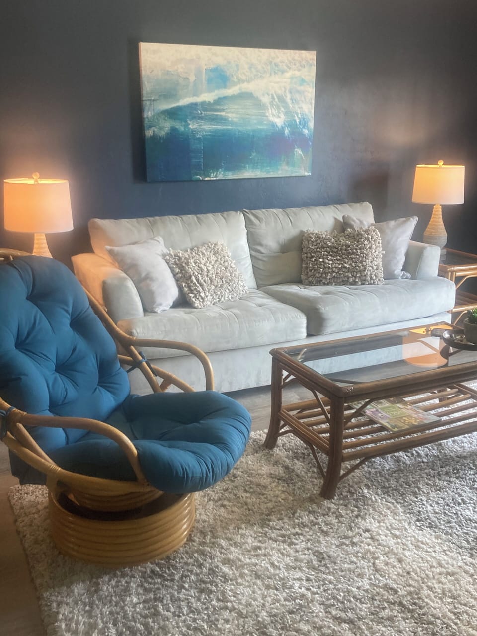 Comfy couch next to patio and beautiful pool .