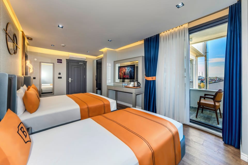 Deluxe Triple Room | Minibar, desk, laptop workspace, soundproofing