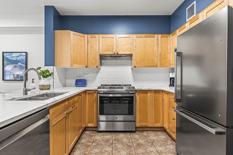 The kitchen has all new stainless steel appliances and a glass cooktop stove for easy cleaning