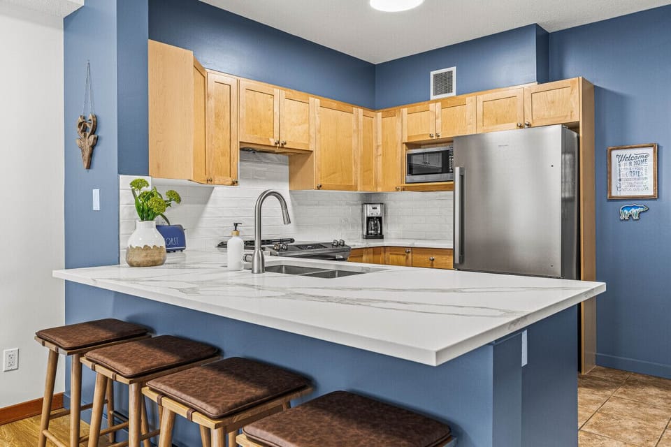 Kitchen has been upgraded with white Italian marble countertops