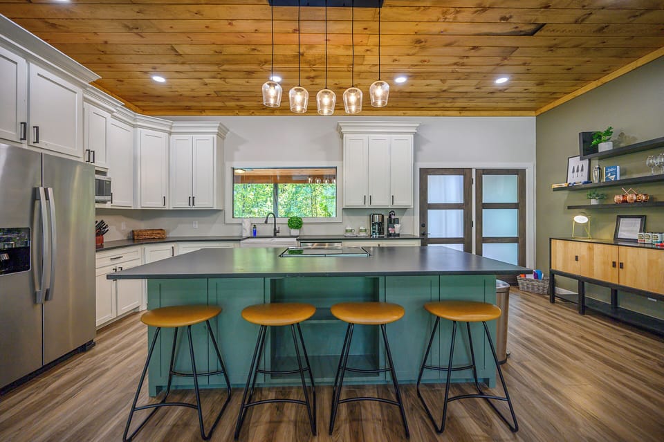 The fully stocked kitchen features an eat-in island and bar stool seating.